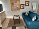 Cozy living room featuring a teal sofa, coffee table, and tasteful wall art at 3315 58Th S Ave # 218, St Petersburg, FL 33712