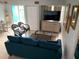 Living room features a teal sofa, coffee table, and wicker chairs at 3315 58Th S Ave # 218, St Petersburg, FL 33712