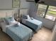 Two twin beds in a condo bedroom with window and view at 3315 58Th S Ave # 218, St Petersburg, FL 33712