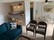 Open concept living room and kitchen with teal sofa and dining area at 3315 58Th S Ave # 218, St Petersburg, FL 33712