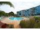 Community pool with lounge chairs and landscaping at 3315 58Th S Ave # 218, St Petersburg, FL 33712