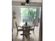 Charming dining area with table and chairs, near sliding glass doors to balcony at 3315 58Th S Ave # 218, St Petersburg, FL 33712