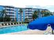 Community pool with lounge chairs and umbrellas at 3315 58Th S Ave # 218, St Petersburg, FL 33712