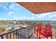 Balcony featuring red chairs and cityscape view, offering a charming outdoor space at 15316 Gulf Blvd # 604, Madeira Beach, FL 33708