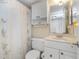 Well-lit bathroom with a shower-tub combo, floral curtains, and white vanity, providing a clean aesthetic at 15316 Gulf Blvd # 604, Madeira Beach, FL 33708