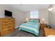 Comfortable bedroom with wood-look floors, dresser, and peaceful ambiance at 15316 Gulf Blvd # 604, Madeira Beach, FL 33708