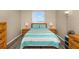 Bright bedroom featuring twin nightstands, window with blinds, and bamboo furniture at 15316 Gulf Blvd # 604, Madeira Beach, FL 33708