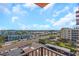 Expansive city view from the balcony overlooking vibrant streets and the distant skyline on a sunny day at 15316 Gulf Blvd # 604, Madeira Beach, FL 33708