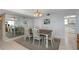 Dining area featuring a wooden table, seating for six, and a mirrored wall at 15316 Gulf Blvd # 604, Madeira Beach, FL 33708