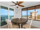 Bright dining area with coastal views, a ceiling fan, and seating for four at 15316 Gulf Blvd # 604, Madeira Beach, FL 33708