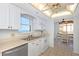 Functional kitchen features a window view, white appliances, and an adjacent dining area with seating at 15316 Gulf Blvd # 604, Madeira Beach, FL 33708
