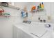 Functional laundry area with washer, dryer and wire shelving for storage and supplies at 15316 Gulf Blvd # 604, Madeira Beach, FL 33708