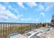 Relaxing lounge chairs on a patio overlooking the beach, inviting residents to unwind and enjoy the ocean breeze at 15316 Gulf Blvd # 604, Madeira Beach, FL 33708