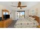 Bright main bedroom featuring ceiling fan, balcony access, and wood-style dresser at 15316 Gulf Blvd # 604, Madeira Beach, FL 33708