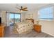 Bright bedroom with a ceiling fan, bedside lamps, and balcony access at 15316 Gulf Blvd # 604, Madeira Beach, FL 33708