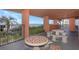 A shaded patio area with stone tables, benches, and lush greenery, offering a serene outdoor space with ocean views at 15316 Gulf Blvd # 604, Madeira Beach, FL 33708