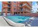 Sparkling community pool next to a building with balconies, creating a refreshing oasis for residents at 15316 Gulf Blvd # 604, Madeira Beach, FL 33708