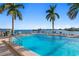 Inviting community pool with waterfront views and palm trees at 5200 Brittany S Dr # 4-1102, St Petersburg, FL 33715