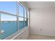 Bedroom with large windows offering stunning water views at 5200 Brittany S Dr # 4-1102, St Petersburg, FL 33715