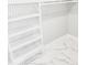 Spacious closet with white shelves and marble floors at 211 Dolphin Pt # 201, Clearwater, FL 33767