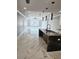 Open living area with marble floors and kitchen island at 211 Dolphin Pt # 201, Clearwater, FL 33767