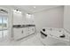 Elegant bathroom with double vanity, soaking tub, and marble flooring at 211 Dolphin Pt # 302, Clearwater, FL 33767