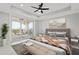 Main bedroom with stunning water views, large windows, and plush bedding at 211 Dolphin Pt # 302, Clearwater, FL 33767
