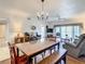 Bright dining area with a wooden table and bench seating, adjacent to the living room at 960 Starkey Rd # 2303, Largo, FL 33771