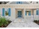 Front entrance with blue door, white porch, and blue shutters at 6622 Summit View Dr, Brooksville, FL 34601