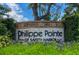 Entrance sign to the 'Philippe Pointe of Safety Harbor' community nestled within lush landscaping at 109 Wateredge Ct, Safety Harbor, FL 34695