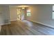 Bright dining room with wood-look floors and view of kitchen at 10033 64Th N Ave # 1, St Petersburg, FL 33708
