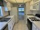 Kitchen with white cabinets, gas stove and stainless steel appliances at 10033 64Th N Ave # 1, St Petersburg, FL 33708