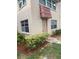 Exterior view of a condo building with a brown door at 10033 64Th N Ave # 1, St Petersburg, FL 33708