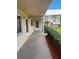 Exterior view of condo building with manicured landscaping and walkway at 10033 64Th N Ave # 1, St Petersburg, FL 33708