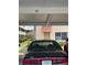 View of parking garage and condo building at 10033 64Th N Ave # 1, St Petersburg, FL 33708