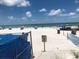 Scenic beach view with umbrellas and calm ocean at 14046 Gulf Blvd # 1, Madeira Beach, FL 33708