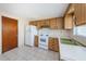 Simple kitchen with wood cabinets and white appliances at 3423 Eisenhower Dr, Holiday, FL 34691