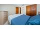 Bedroom with dresser and double doors leading to closet at 3423 Eisenhower Dr, Holiday, FL 34691