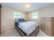 Bedroom with wood-like platform bed and dresser at 3423 Eisenhower Dr, Holiday, FL 34691