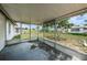 Covered screened porch overlooks backyard at 3423 Eisenhower Dr, Holiday, FL 34691