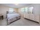 Spacious bedroom with a dresser and large platform bed at 3423 Eisenhower Dr, Holiday, FL 34691