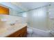 Bathroom with shower/tub combo, vanity, and floral wallpaper at 3423 Eisenhower Dr, Holiday, FL 34691