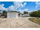 White brick house with a single car garage and a large front yard at 3423 Eisenhower Dr, Holiday, FL 34691