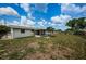 Large backyard with a home and patio at 3423 Eisenhower Dr, Holiday, FL 34691