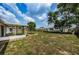 Large backyard with covered patio at 3423 Eisenhower Dr, Holiday, FL 34691