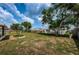 Backyard with grassy area and trees at 3423 Eisenhower Dr, Holiday, FL 34691
