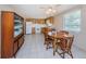 Cozy kitchen with wood cabinets, white appliances, and adjacent dining area at 3423 Eisenhower Dr, Holiday, FL 34691