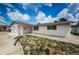 White brick house with attached garage and a large front yard at 3423 Eisenhower Dr, Holiday, FL 34691