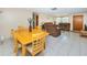Dining area with wood table and chairs, offering access to the living room at 3423 Eisenhower Dr, Holiday, FL 34691