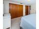 Bedroom with double doors leading to closet and ensuite bathroom at 3423 Eisenhower Dr, Holiday, FL 34691